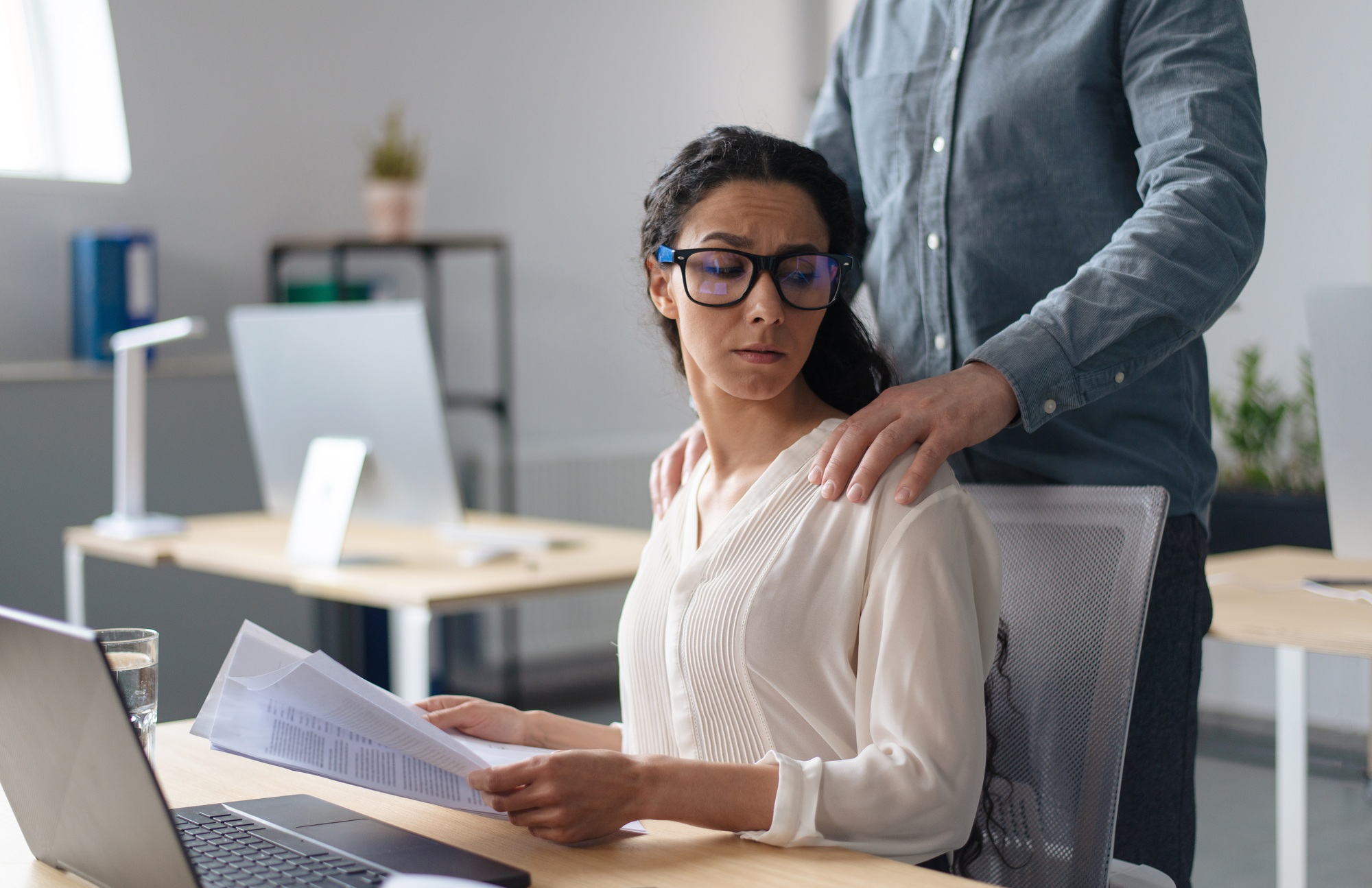 Beautiful young woman being victim of sexual harassment at workplace, copy space