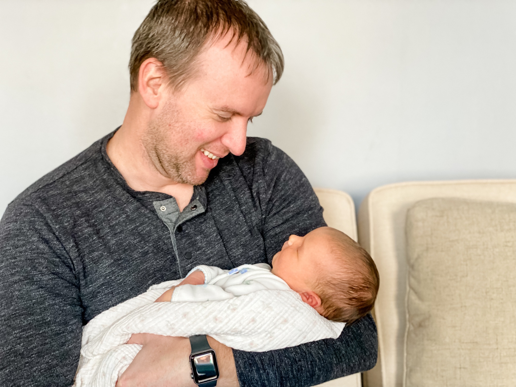 Dad holding new baby daughter