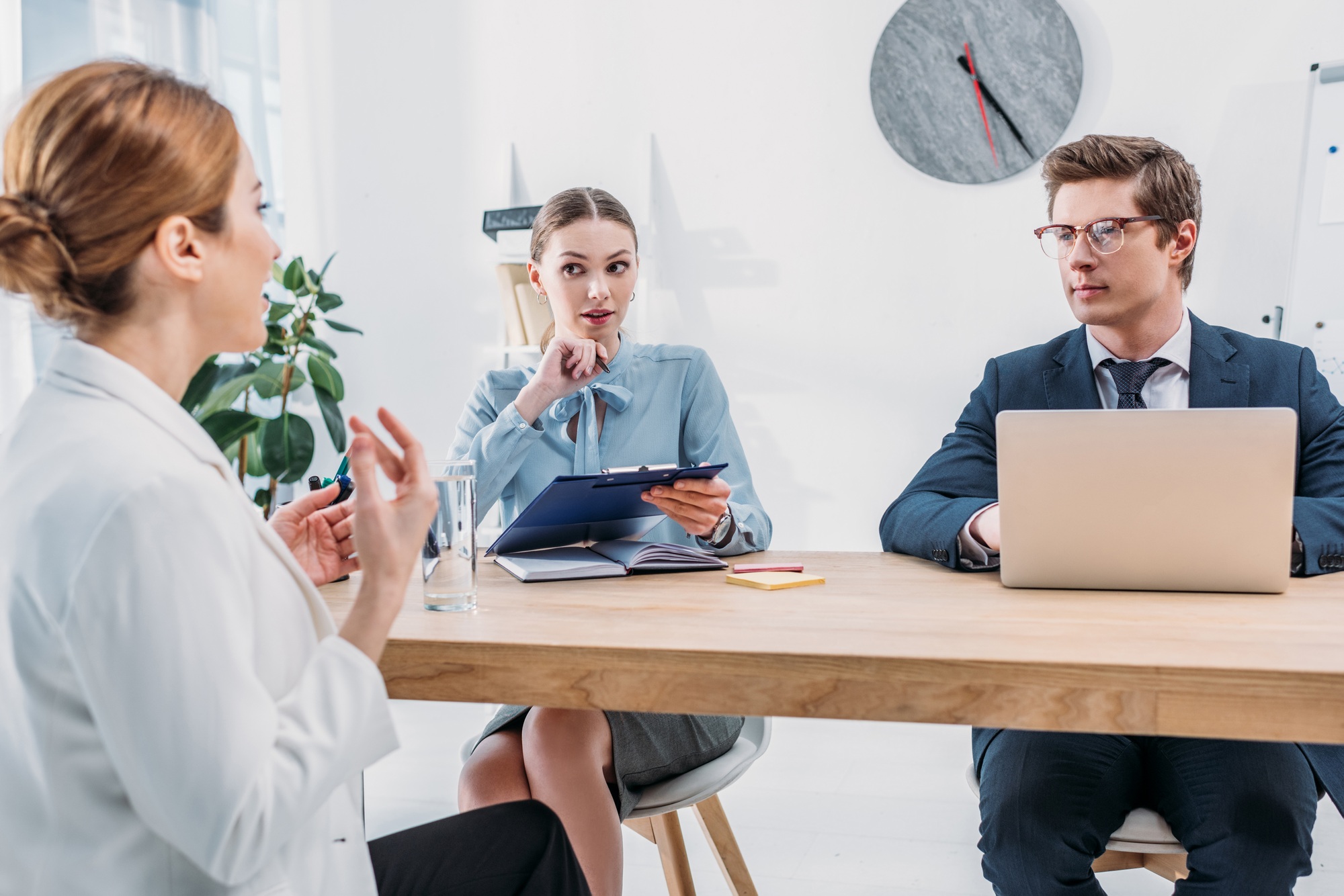 recruiters looking at employee talking on job interview